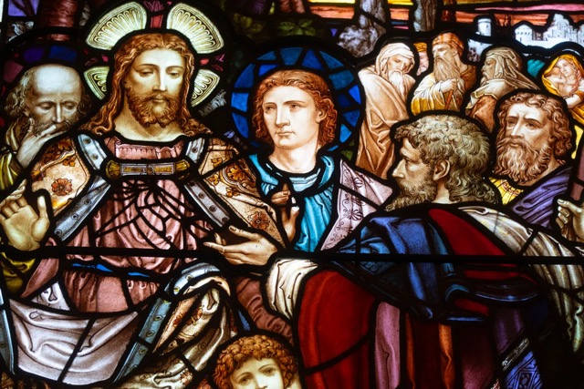 A jewel-toned figurative stained-glass window